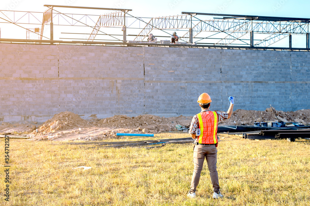 Engineer technician watching team of workers on high steel platform, Engineer technician Looking Up and Analyzing an Unfinished Construction Project. Engineer technician watching team of workers on high steel platform, Engineer technician Looking Up and Analyzing an Unfinished Construction Project.