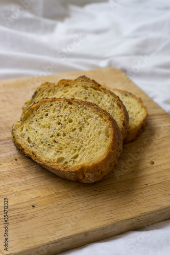 Corn bread slices over a wooden table on a white sheet background. Yellowish bread.