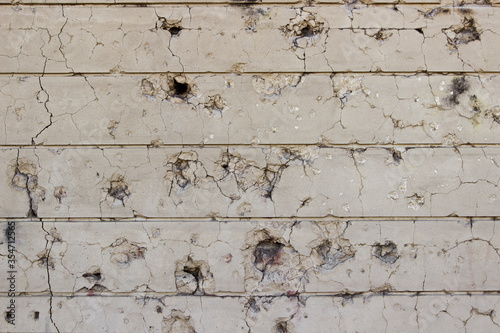 Concrete wall background with bullet holes. Concrete wall background.