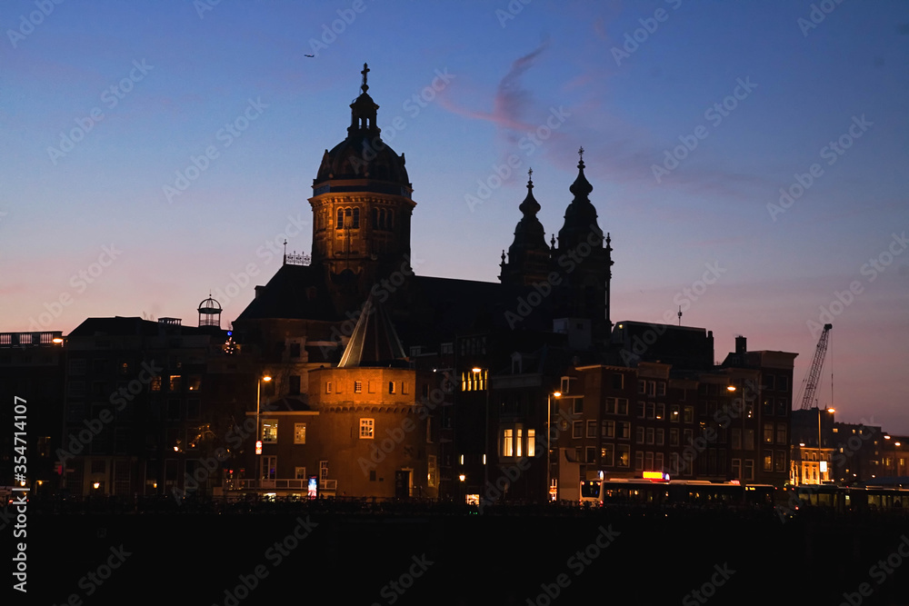 The Basilica of Saint Nicholas  illuminated  at sunset  , Amsterdam city, the most touristic city of netherlands.