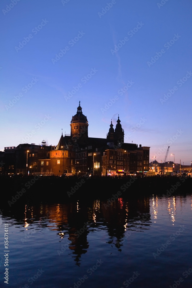 The Basilica of Saint Nicholas  illuminated  at sunset  , Amsterdam city, the most touristic city of netherlands.