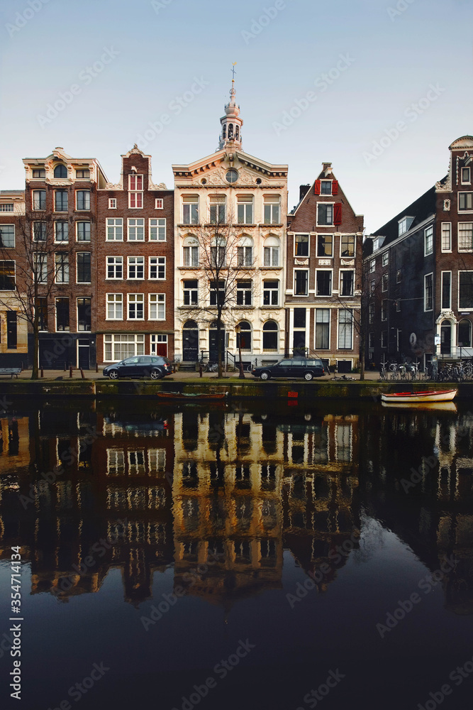 Dutch architecture reflected on the canals, the characteristic houses of Amsterdam, the most touristic city of the netherlands