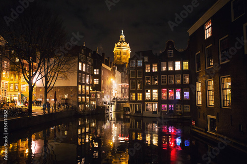 Night view of Amsterdam city with canal and Basilica of Saint Nicholas   famous landmark view from the Armbrug bridge  Netherlands  Holland  Europe.