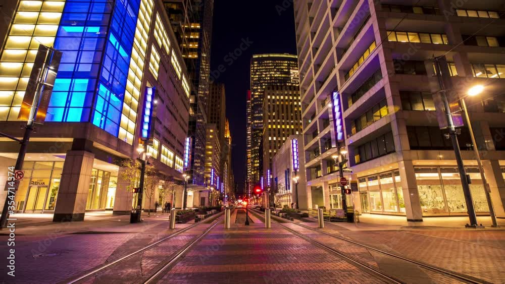Houston, Texas / USA - February 6, 2020: A time-lapse of traffic and metro light rail trains racing through Downtown Houston, Texas on a busy weeknight evening.