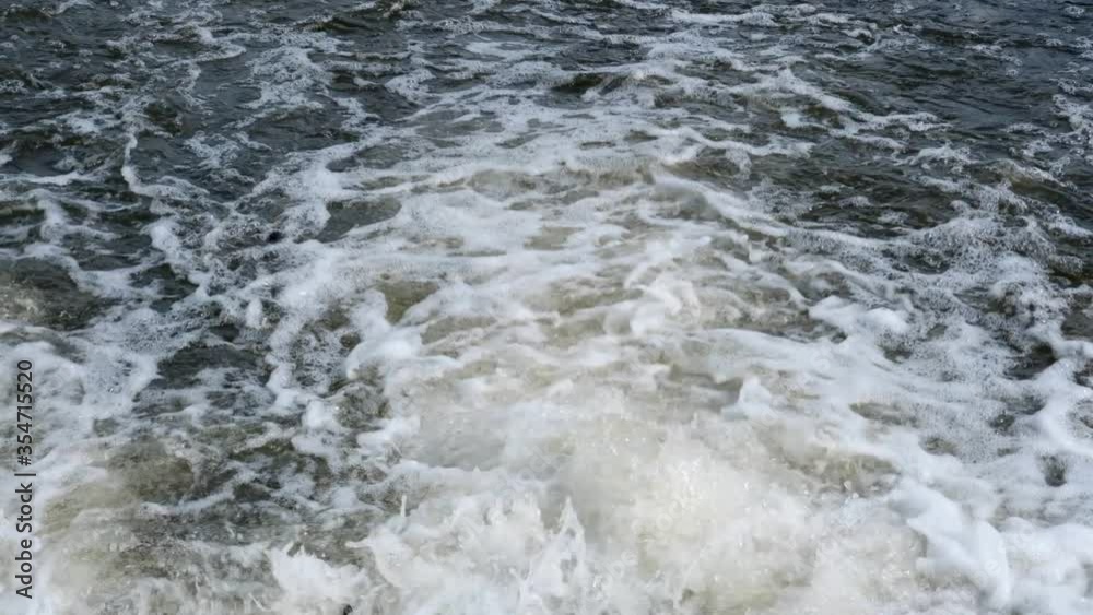 Rushing water in a mountain shallow river in slow motion video Rushing water in a mountain shallow river in slow motion video