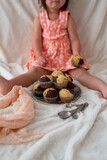 Toddler Girl Eating Muffins
