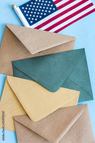 American flag and colorful envelopes on blue background.