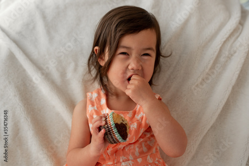 Little Girl Eating Muffins