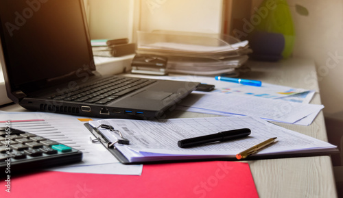 Laptop on a desk. Window in the background. Working from home. Designer desk. Freelance job.