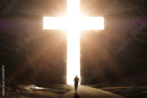 Bild auf Leinwand Man Running Towards Giant Bright Cross with Glowing Rays