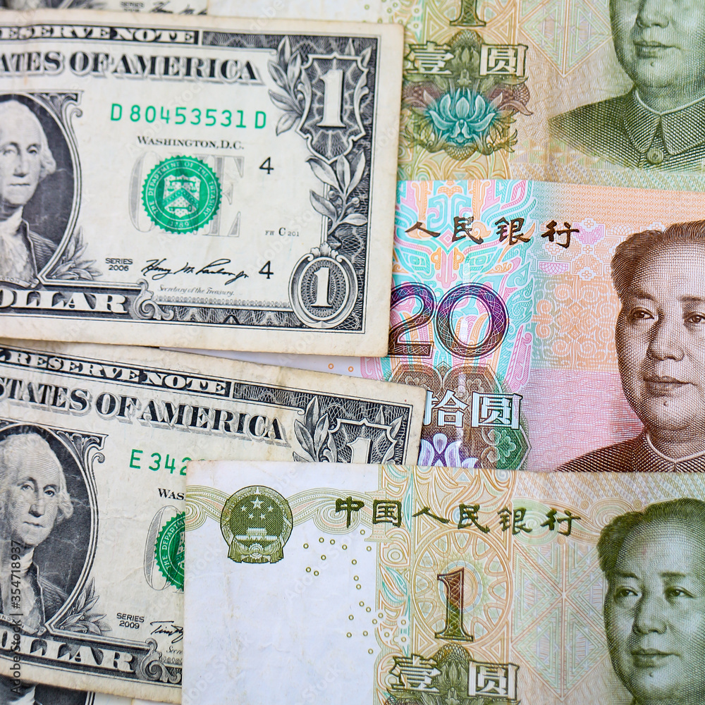 Fototapeta premium Currencies of major world economies United States and China: US Dollars and Chinese Yuan banknotes.