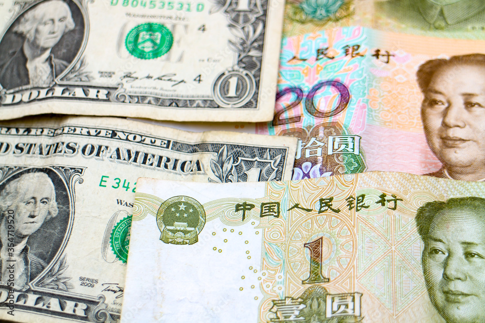 Currencies of major world economies United States and China: US Dollars and Chinese Yuan banknotes.
