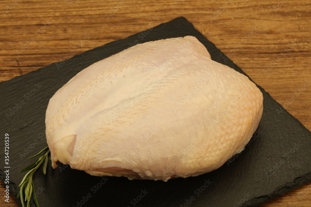 Raw whole chicken breast with skin Raw whole chicken breast with skin