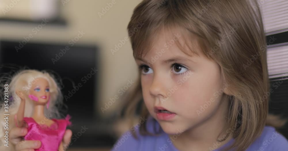 Adorable little girl sitting and playing with a pencil Adorable little girl sitting and playing with a pencil