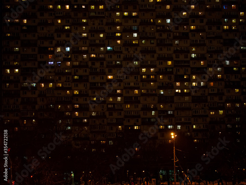 Light in the windows of an apartment building at night