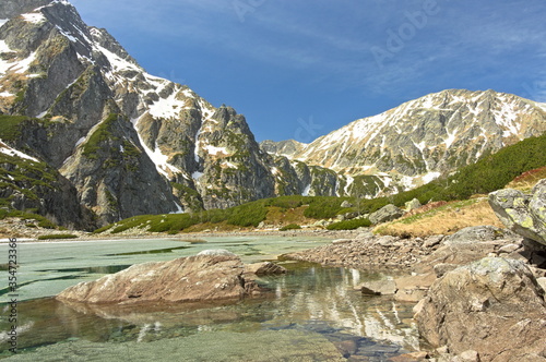 Poland Tatra Mountains (Czarny Staw pod Rysami). View of the pond in the Tatra Mountains. Descending ice from the spring lake in the Tatra Mountains. photo