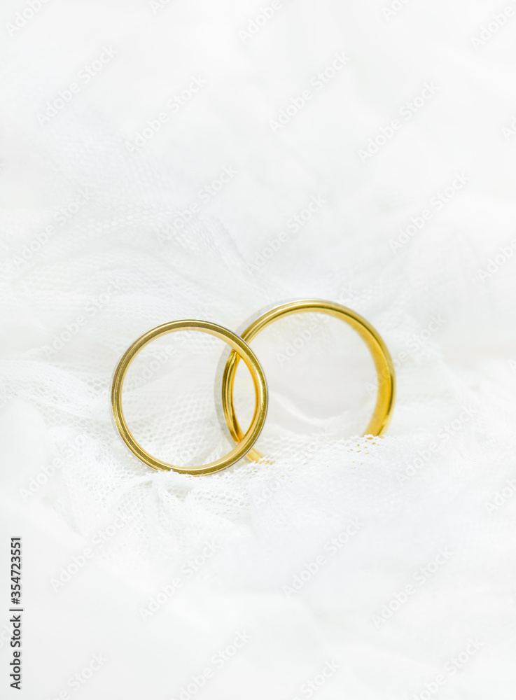 Close-up Wedding ring on white lace background Close-up Wedding ring on white lace background