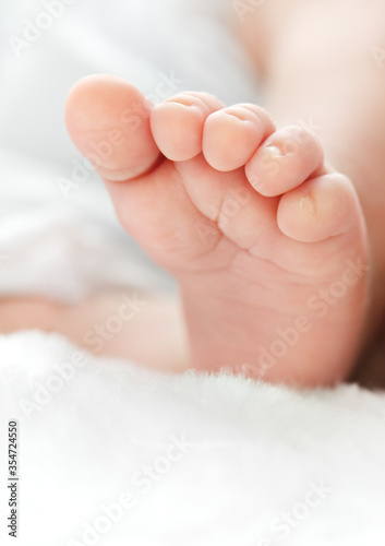 Newborn's foot on white blanket for your a baby shower card