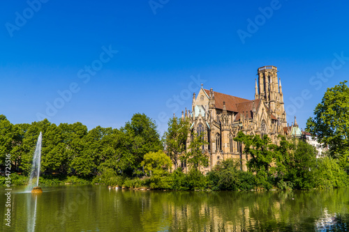 The Gothic Johanneskirche am Feuersee - Johannes church at Feuersee park witha fountain in Stuttgart, Germany photo