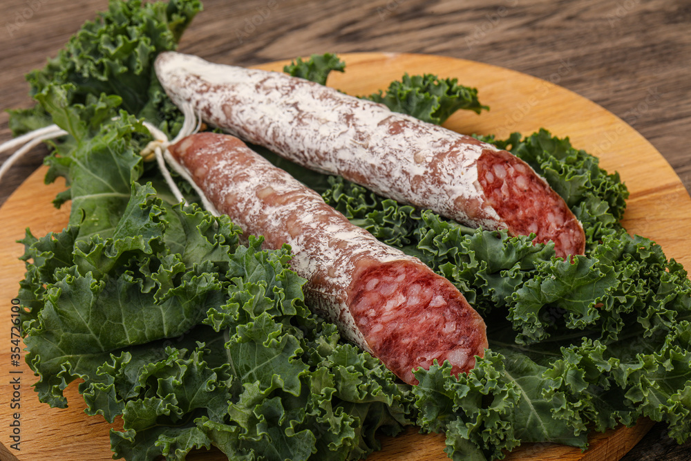 Spanish Fuet sausage with salad leaves Spanish Fuet sausage with salad leaves