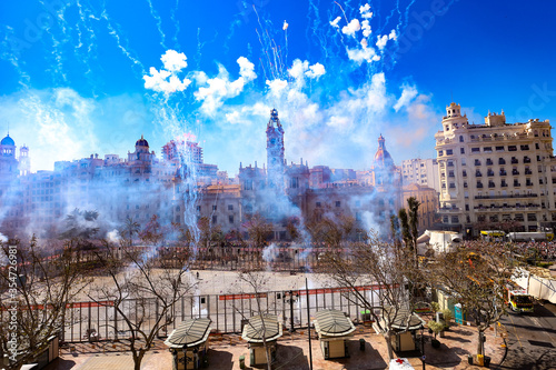 Mascletá during the Fallas of Valencia on the Town Hall Square (Plaça de l'Ajuntament). The fireworks festival has been named an immaterial Unesco world heritage.  photo