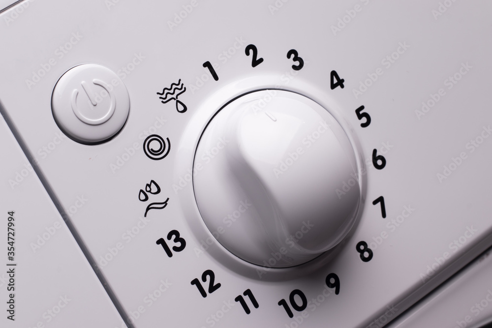 Washing machine control panel. Round knob for choosing the washing mode and power button. Washing machine control panel. Round knob for choosing the washing mode and power button.