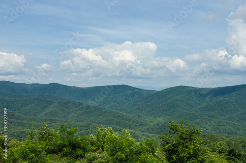 Open valley of tree covered mountains on beautiful day in rural Georgia