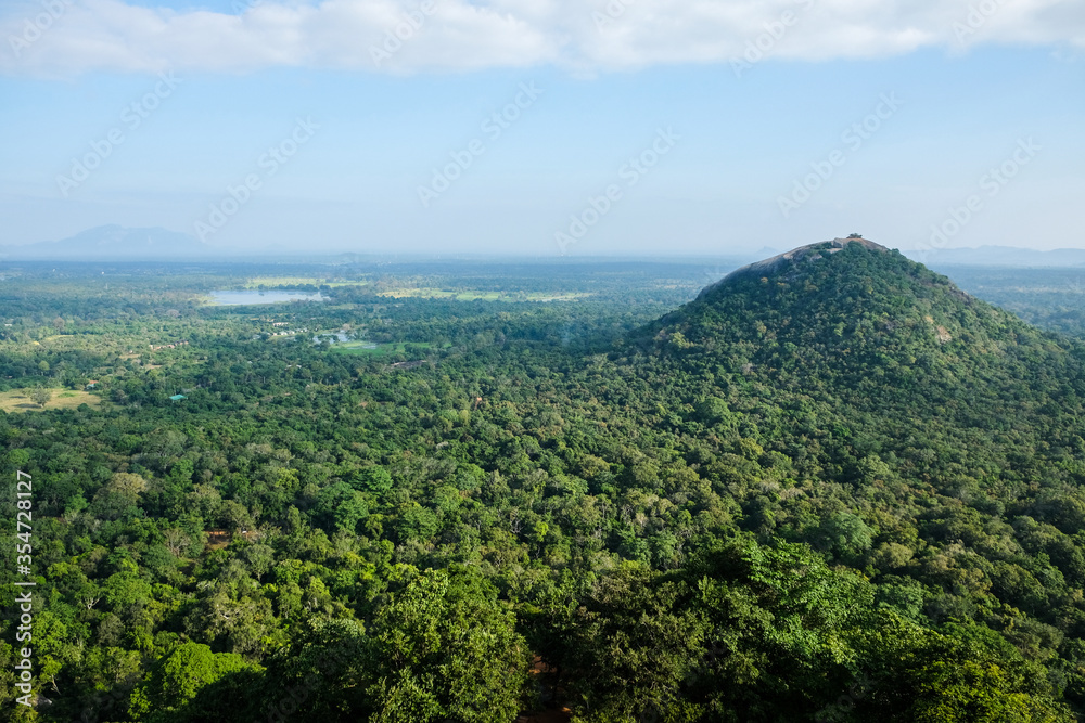 Scenic view at Pidurangala Rock hill from the top of Lion Rock Fortress. Hiking in Sri Lanka: beautiful viewpoint at the famous historical site Sigiriya Rock.