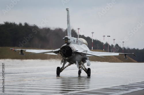 Принти на полотні f16 fighter jet from behind on the wet ground in poland during presentation