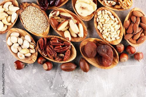 Fototapeta Naklejka Na Ścianę i Meble -  Composition with dried fruits and assorted healthy nuts in wooden bowls