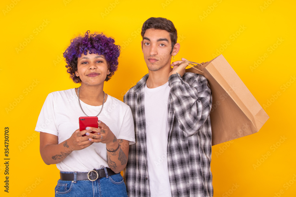 young couple with shopping bags and mobile phone