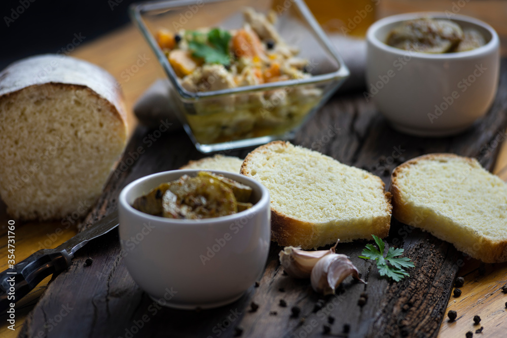 
minced pickles on wooden board and homemade bread cut into slices, food still life for minced with homemade food