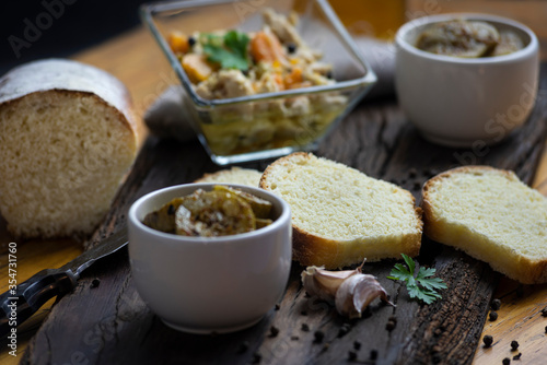 
minced pickles on wooden board and homemade bread cut into slices, food still life for minced with homemade food