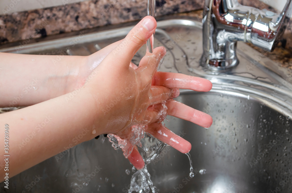 Fototapeta premium Washing hands under the water tap or faucet without soap. Hygiene concept detail.
