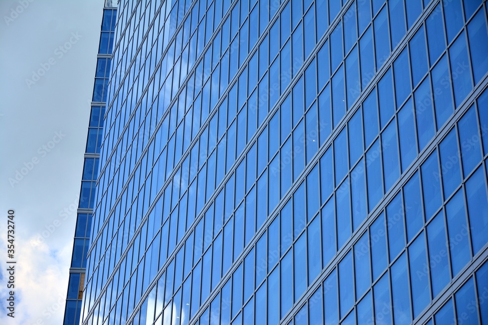 Facade texture of a glass mirrored office building. Fragment of the facade. Modern architecture of the office building. Facade texture of a glass mirrored office building. Fragment of the facade. Modern architecture of the office building.