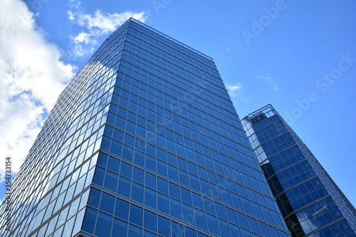 Facade texture of a glass mirrored office building. Fragment of the facade. Modern architecture of the office building.