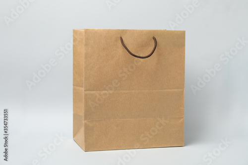 Empty paper bag on white background, space for text