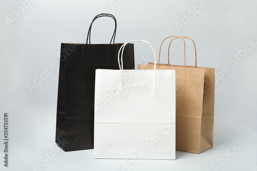 Empty paper bags on gray background, space for text.