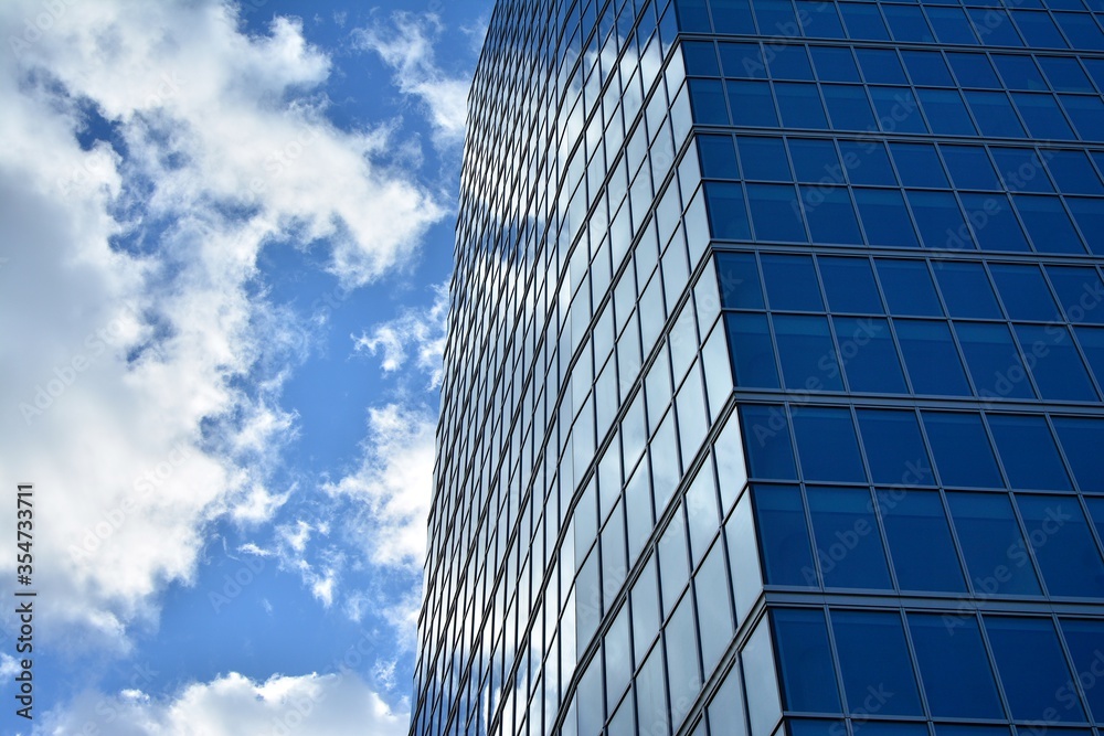 Facade texture of a glass mirrored office building. Fragment of the facade. Modern architecture of the office building. Facade texture of a glass mirrored office building. Fragment of the facade. Modern architecture of the office building.