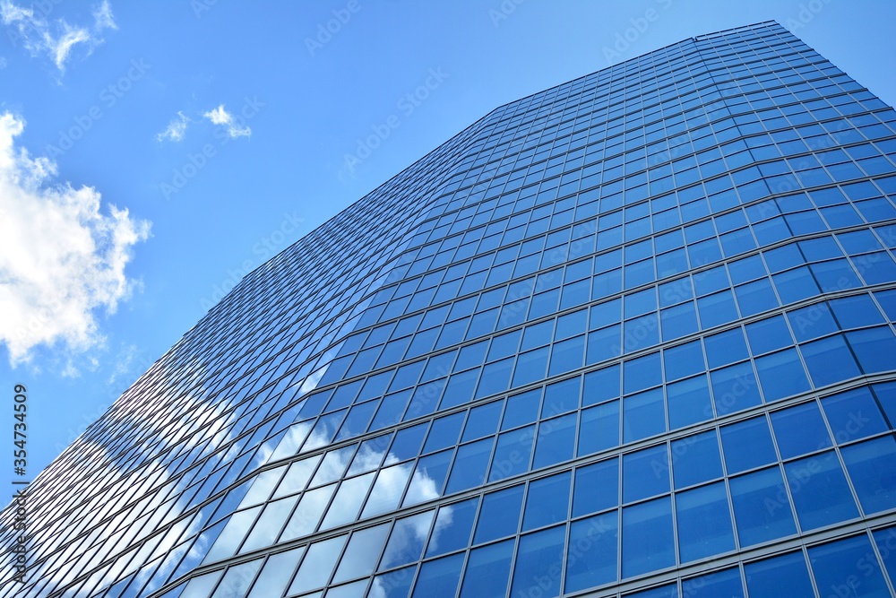 Facade texture of a glass mirrored office building. Fragment of the facade. Modern architecture of the office building. Facade texture of a glass mirrored office building. Fragment of the facade. Modern architecture of the office building.