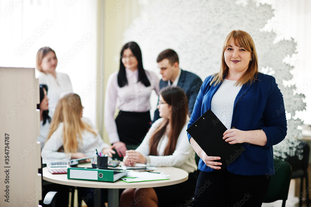 © AS Photo Family - Portrait of caucasian woman against business people group of bank workers have meeting and working in modern office. © AS Photo Family - Portrait of caucasian woman against business people group of bank workers have meeting and working in modern office.