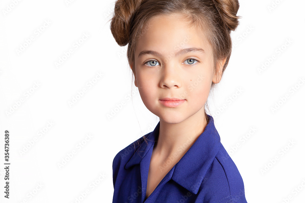 Portrait of a teenager. Beautiful European teen girl in blue dress on white background. Genuine leather without makeup. Skin and hair care. Face for advertising. Portrait of a teenager. Beautiful European teen girl in blue dress on white background. Genuine leather without makeup. Skin and hair care. Face for advertising.