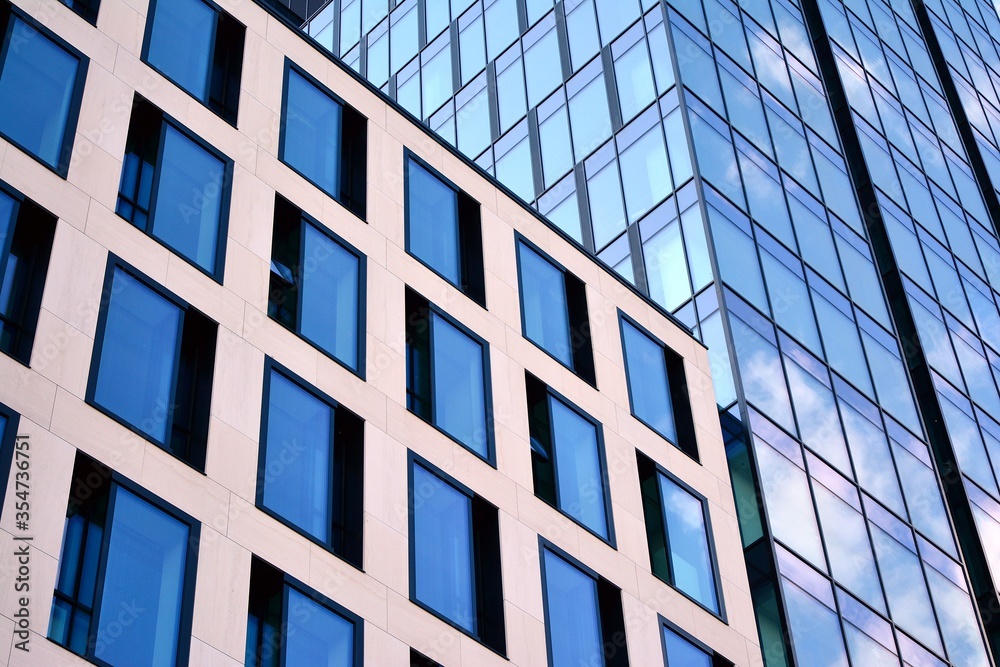 Facade texture of a glass mirrored office building. Fragment of the facade. Modern architecture of the office building. Facade texture of a glass mirrored office building. Fragment of the facade. Modern architecture of the office building.