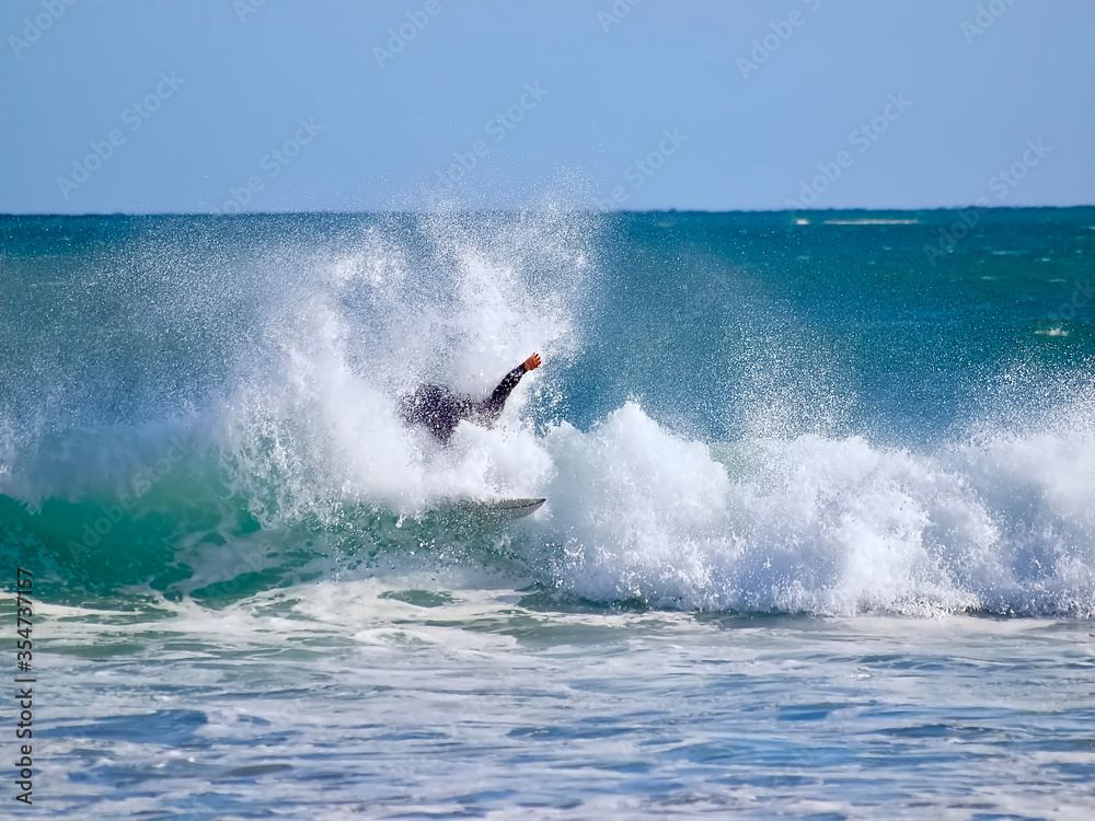 Surfer on his board sporting in the ocean