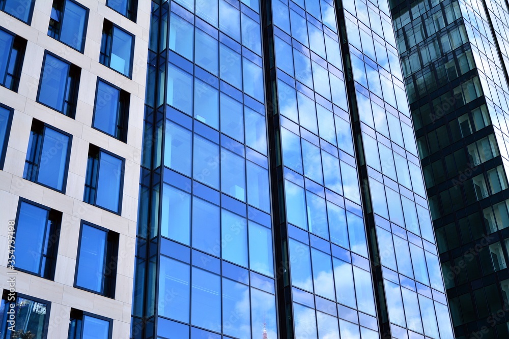 Facade texture of a glass mirrored office building. Fragment of the facade. Modern architecture of the office building.