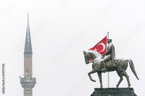 Republic Square in Kayseri. Ataturk statue turkish flag and mosque in the same photo, under snow