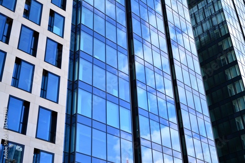 Facade texture of a glass mirrored office building. Fragment of the facade. Modern architecture of the office building.