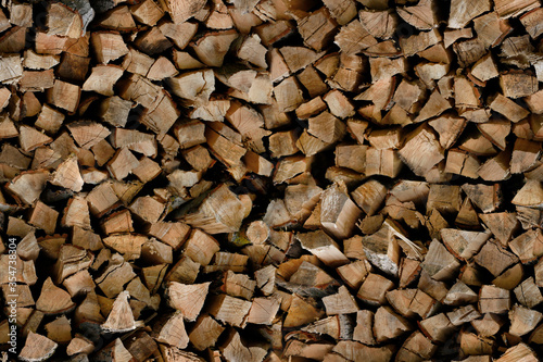 Seamless pattern of brown chopped firewood, woodpile in the village