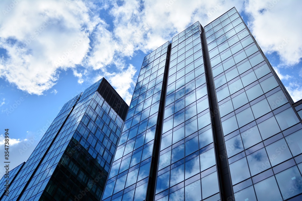 Facade texture of a glass mirrored office building. Fragment of the facade. Modern architecture of the office building. Facade texture of a glass mirrored office building. Fragment of the facade. Modern architecture of the office building.