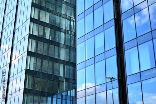 Facade texture of a glass mirrored office building. Fragment of the facade. Modern architecture of the office building.